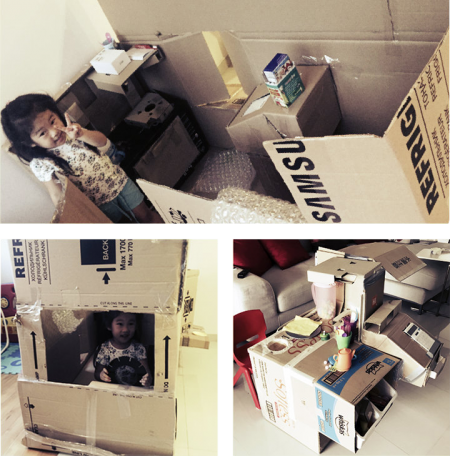 Kids playing in cardboard kitchen